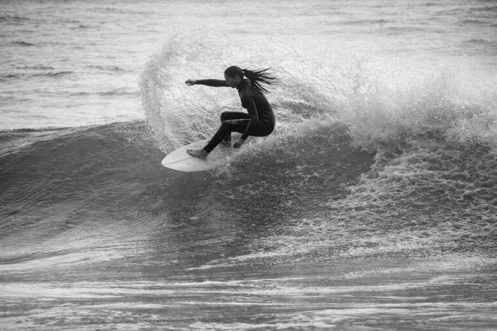 black-and-white-female-surfer-riding-shortboard