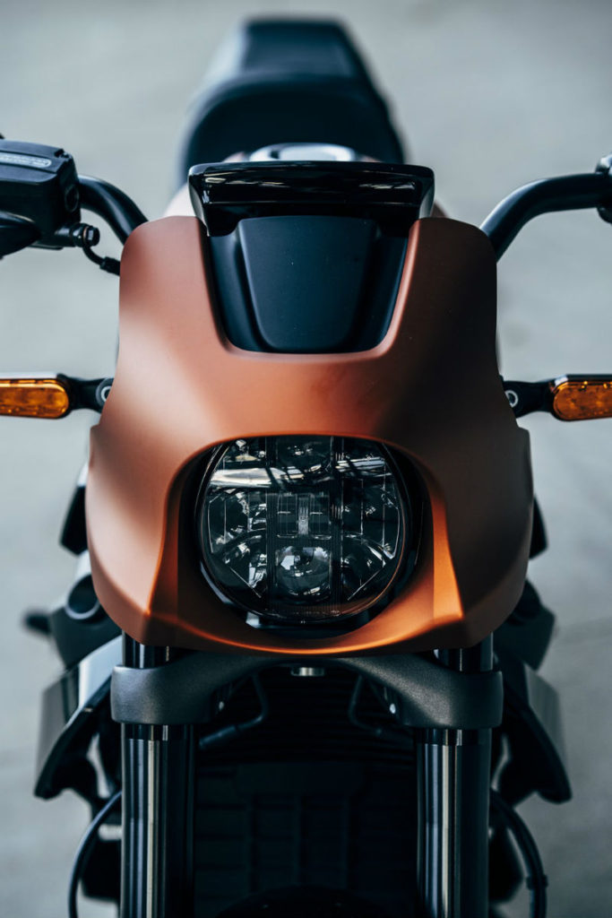 Harley-Davidson’s first venture into the electric motorcycle arena will finally arrive later this summer. The LiveWire first introduced back in 2014, is now available for pre-order with an August - September 2019 launch date. Earlier this year at the Consumer Electronics Show (CES) in Las Vegas, Harley-Davidson unveiled the base price $29,799 US, of the 2020 LiveWire. Seating the bike in the upper echelons of the brand's price range. According to Harley-Davidson, the company is anticipating that the release of their first EV motorcycle will reverse slowing sales and nosediving stock value by appealing to a new breed of rider - the 18-to-35-year-old demographic. Steep retail price aside, the LiveWire looks absolutely stunning with a futuristic design and a full-colour TFT display, which connects the riders smartphone to the new new H-D Connect app-based operating system. The system monitors the bike’s diagnostics, charge status, will provide turn-by-turn navigation and receives security alerts. Time will tell whether the zero-emissions bike thrusts the Milwaukee company into the electric motorcycle stratosphere successfully or not. The LiveWire's Electronic Chassis Control (ECC), manages cornering-enhanced Anti-lock Braking System (ABS), Traction Control System (TCS) and Drag-Torque Slip Control System (DSCS) by modulating torque available at the rear wheel. Located on the top of the gas tank is the onboard Level 1 charger and power cord which connects to any standard household outlet and get a full charge overnight. Using a stage-three supercharger connection, the batteries will charge from zero to 80 per cent capacity in approximately 40 minutes. With the H-D CONNECT SERVICE, you can connect remotely through your smartphone to receive bike vitals like battery charge status, see its location on a map, and get security alerts if it’s been bumped, tampered with or moved. The LiveWire™ motorcycle features a high-voltage battery (or RESS; Rechargeable Energy Storage System) composed of lithium-ion cells surrounded by a finned, cast-aluminum housing. The high-voltage battery provides 225 km of city range or 142 km of combined stop-and-go and highway range Harley Davidson claims a 0-60 mph time of 3.5 seconds, with instant power the moment the throttle is twisted. The LiveWire comes outfitted with an adjustable suspension, Brembo brakes with ABS and traction control. Custom designed 180mm rear, and 120mm front Michelin Scorcher Sports tires.