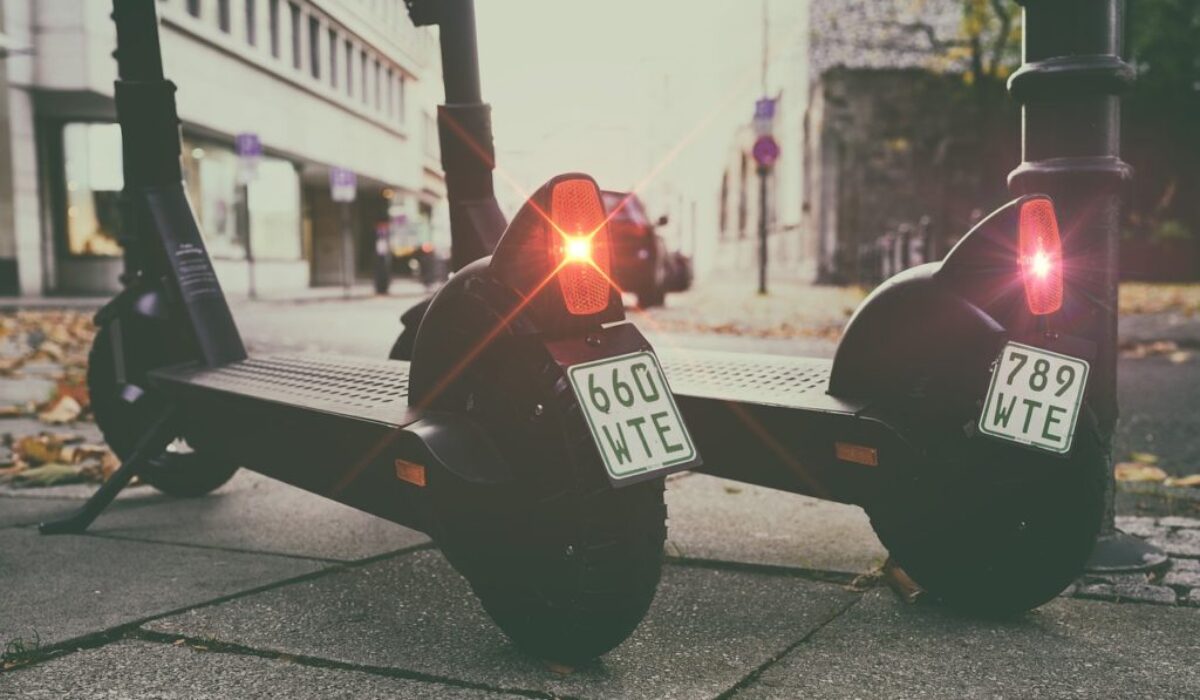 two-black-e-scooters-side-by-side-on-city-street