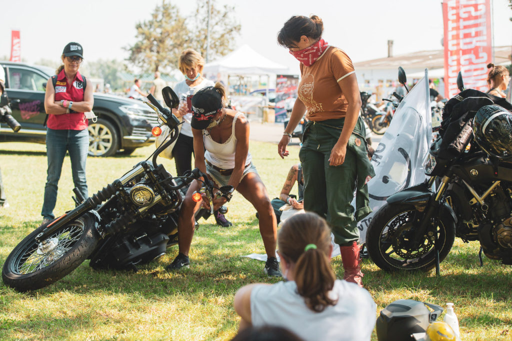 female-lifting-downed-motorcycle-photo-by-andrea-caiola-courtesy-WMBootcamp