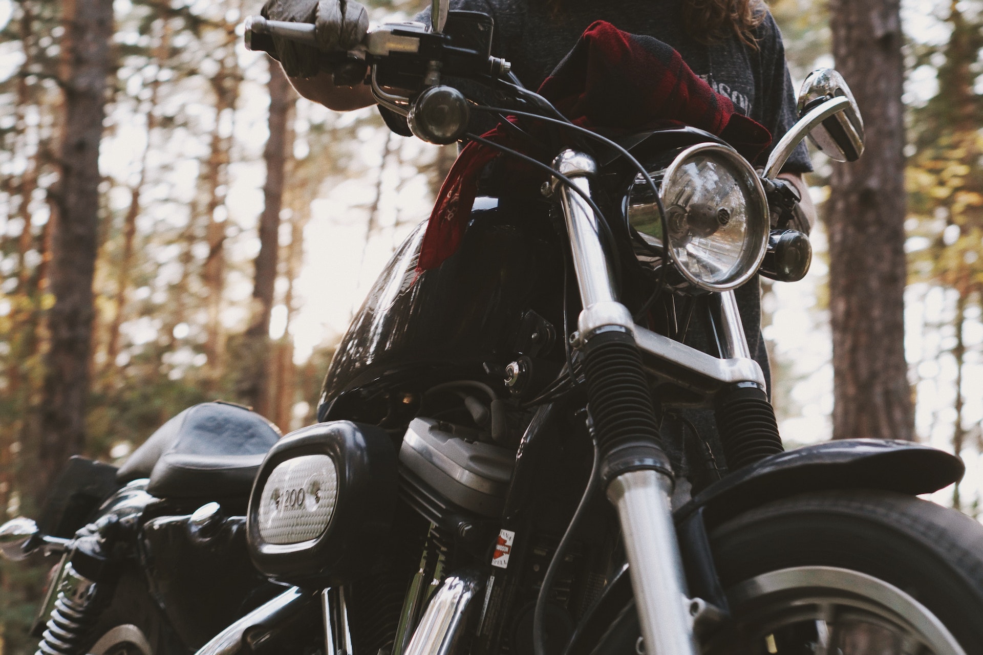 close-up-photograph-of-person-holding-black-motorcycle