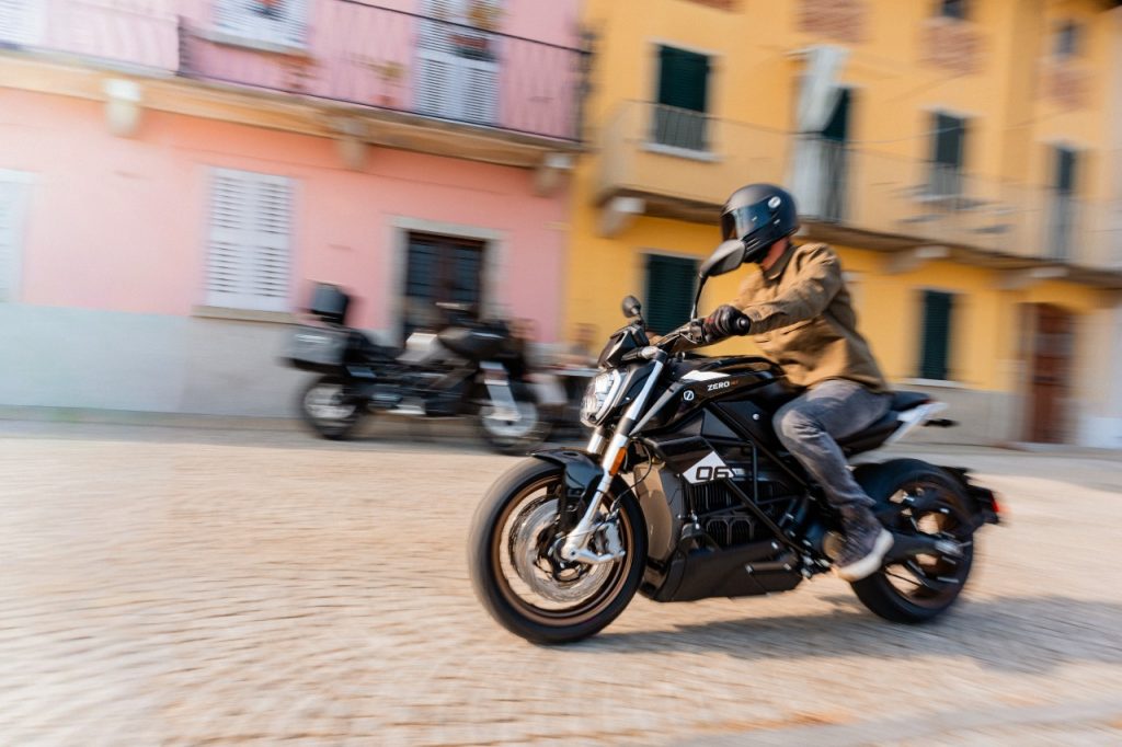 Rider on a Zero SR/F electric motorcycle riding on a paved road.