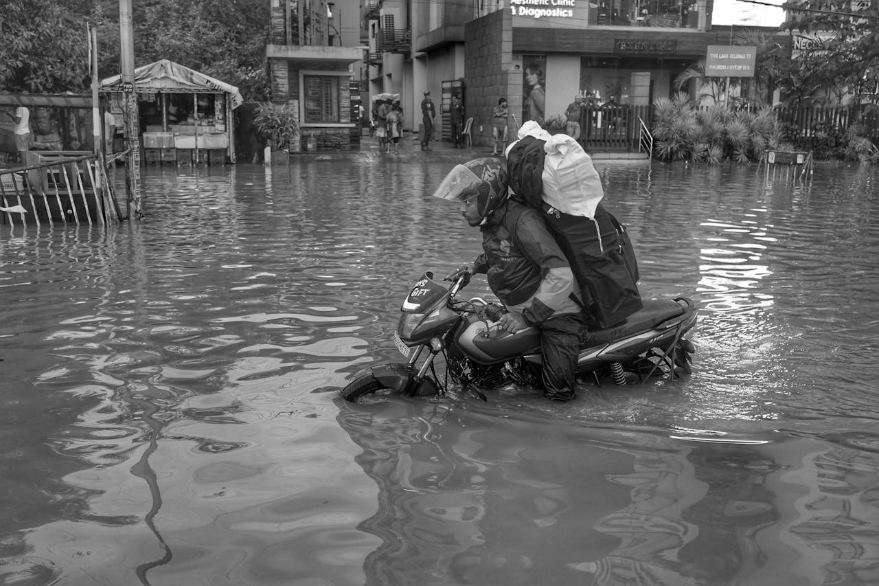 man-driving-on-a-motorcycle-through-the-flooding-21960690/
