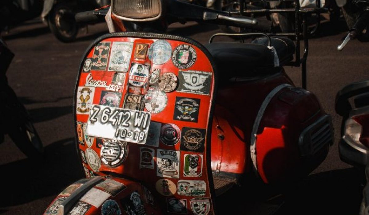 close up vintage vespa scooters with stickers accessories luggage rally gathering detail