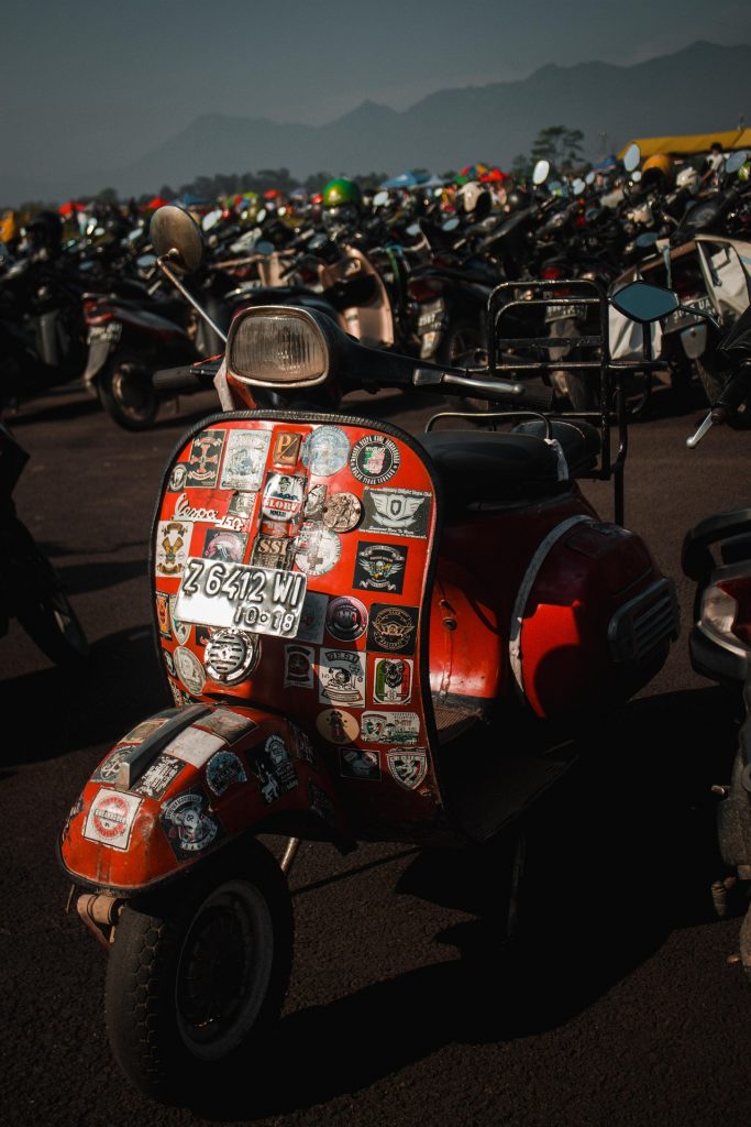 close up vintage vespa scooters with stickers accessories luggage rally gathering detail