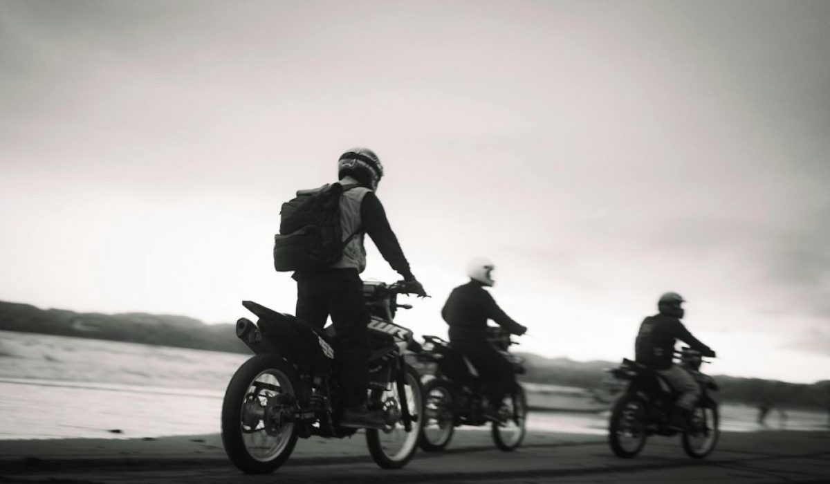 motorcycle riders cruising along the seashore