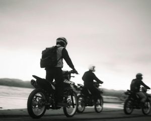 motorcycle riders cruising along the seashore
